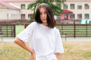 Teenager stands at the volleyball net at the school sports stadium