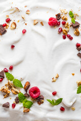 Obraz na płótnie Canvas Whipped cream of egg whites with chocolate, nutmeg and raspberries.
