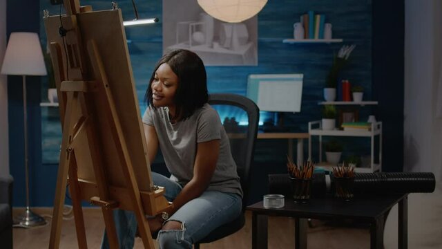 Adult of african american ethnicity working on fine art concept in artwork studio room at home. Black young artist designing drawing of vase for next successful masterpiece project