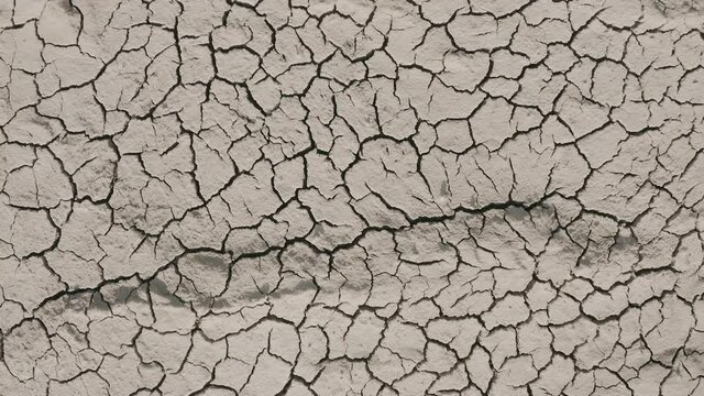 drought concept - water scarcity, climate change, global warming. drops of water are falling. splash of water, dry soil on the background. ecology concept, natural landscape. use of water resources