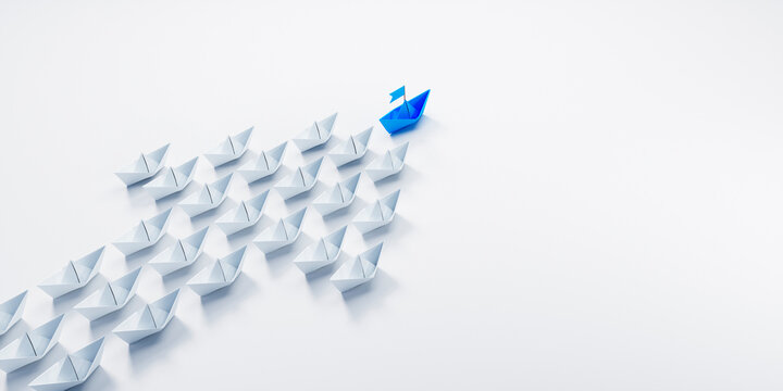 Arrow shaped group of paper boats with blue leader going in same direction - 3D illustration