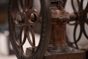 Large manual coffee grinder. Blurred background in cafe