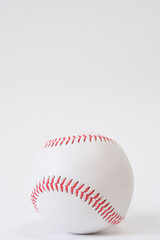 baseball ball with red threads on white paper background