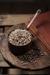 sunflower seeds in cup on the wooden background