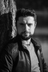 Black and white profile portrait of a serious bearded modern businessman in a stylish leather jacket. Stylish business casual style for men, portrait concept