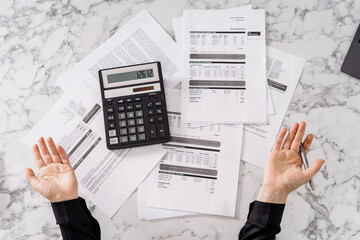 Person surprised by cost of monthly bills