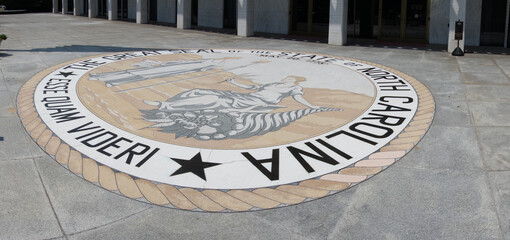 The front entrace of the North Carolina State Legislature building in Raleigh with the state seal...
