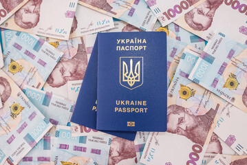 Ukrainian passports on hryvnia background