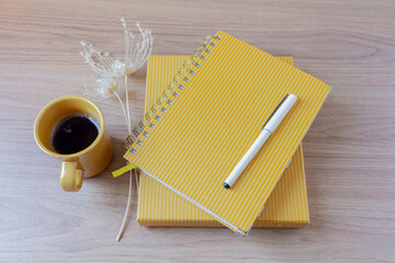 Female home office desk workspace with a planner and stationery on a wooden background. Flat lay, top view. Lifestyle blog, social media composition.