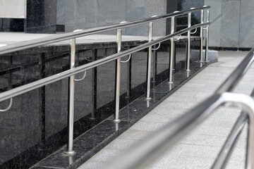 Close up of the metal railings at the entrance to the office building  in grey tones. Selective...