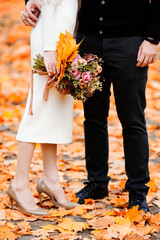 bride and groom walking in autumn park