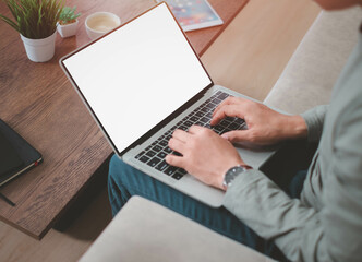 Fototapeta premium image of laptop computer notebook with blank monitor white screen display with Businessman using and typing keyboard working project. Business investment-finance accounting concept.