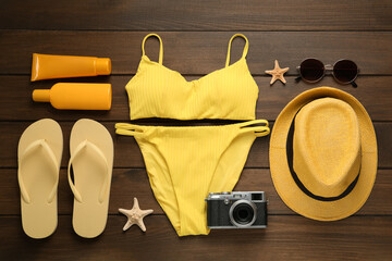 Different beach objects on wooden background, flat lay
