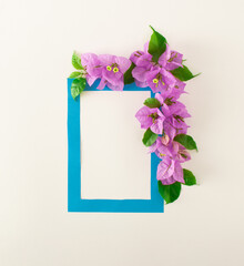 Creative layout made of flowers and leaves on bright background. Minimal summer romatic vacation composition. Top view.