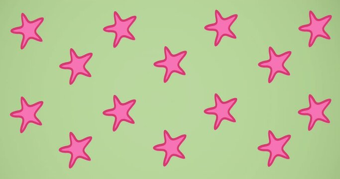 Animation of pink starfish spinning on green background