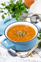 healthy lunch. spicy pumpkin soup with lentils in a saucepan, vertical top view