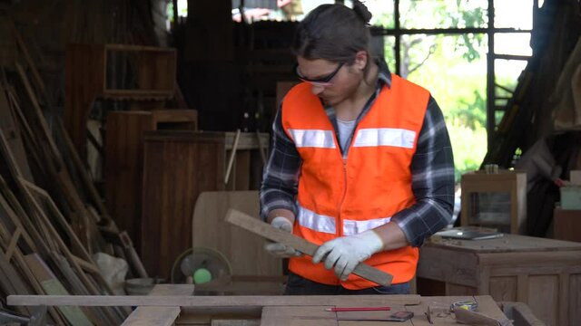carpenter measure distance with a pencil and a tape measure wood  in workshop .craftsman Mark point to cutting on plank