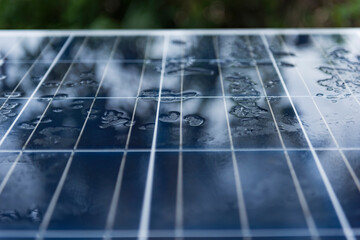 Solar panel with rain drops on a nano coating. Renewable energy from the sun, green power, concept...