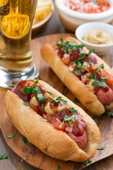 hot dogs with tomato salsa and onions, close-up