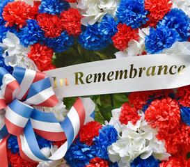 A Veterans memorial wreath with red, white, and blue silk flowers and an 