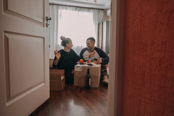 Moving day celebration. Yong couple Move Into New Home. Young happy couple, newlyweds family...