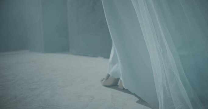 4k Closeup of female legs in high heels .  Rear back view of girl walking inside dark maze. Footage of mystic video of bride. Vision of mystical dream . Shot on ARRI ALEXA Cinema Camera in slow motion