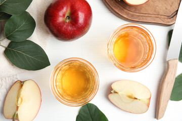 Flat lay composition with delicious apple cider on white wooden table