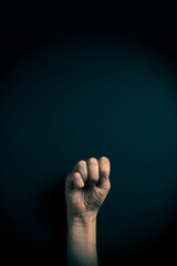 Colour image of hand demonstrating ASL sign language letter M with empty copy space