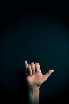 Colour image of hand demonstrating ASL sign language letter Y with empty copy space