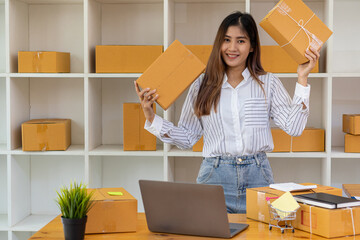 Starting a Small Business, SME Owners, Female Entrepreneurs Have worked with boxes and laptops to check online orders to prepare the boxes. Selling to customers. Online SME business idea.