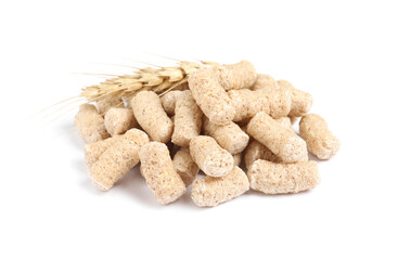 Pile of granulated wheat bran and spikelet on white background