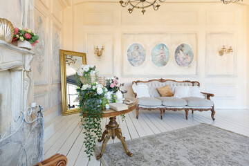 luluxury rich sitting room interior in beige pastel color with antique expensive furniture in baroque style. walls decorated with stucco and frescoes