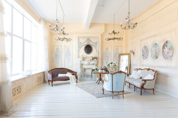 luluxury rich sitting room interior in beige pastel color with antique expensive furniture in baroque style. walls decorated with stucco and frescoes