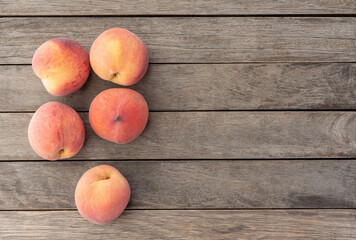 A group of peaches over wooden table with copy space
