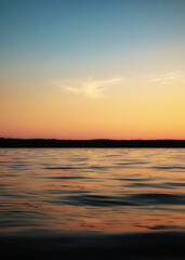 Sunset on the river. Bright summer evening background.