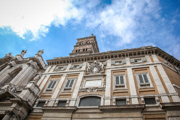 The bell tower of The Basilica of Saint Mary Major (Italian: Basilica di Santa Maria Maggiore) in Rome, against the background of a blue cloudy sky