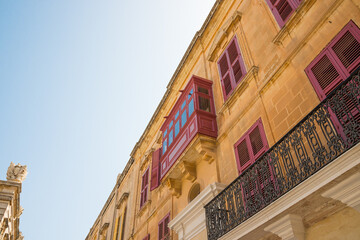 Low-angle shot of aa building with typical bow windows in Malta