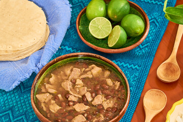 Carne en su jugo served in clay plate on wooden table. Mexican Food Concept.