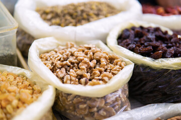 Close-up view of various dried fruits from Morocco on display at a traditional food market. Close-up of peeled nuts