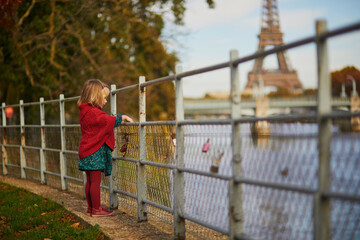 Obraz premium Adorable toddler girl playing in autumn park
