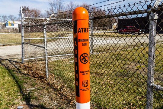 Indianapolis - Circa February 2017: AT&T Warning Post marking underground cables and a note to call 811 before digging I