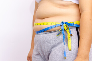 Beautiful fat woman with tape measure She uses her hand to squeeze the excess fat that is isolated...