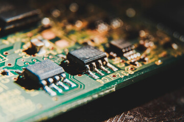 MOSFET and diode on a green circuit board with printed lettering to label the components