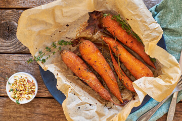 Baked carrots with thyme, maple syrup, garlic and pistachios. White sauce with pistachios.