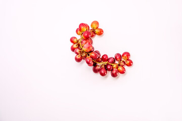 Top view image of bunch of red grapes on white background