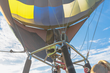 Preparing for a flight in a hot air balloon.A burner with its super hot flame light up inside of a hot air balloon