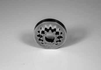 Closeup of two metallic gray gears on the white surface