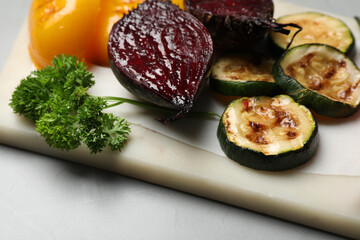 Delicious grilled vegetables on light table, closeup