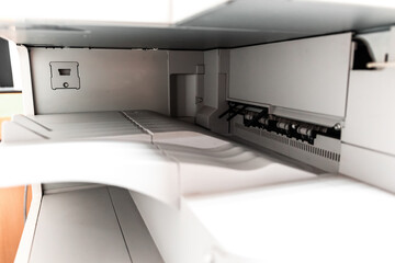 Close up of photocopy machine paper output tray where printed copy are stored at