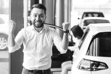 Business man buying a car in a showroom